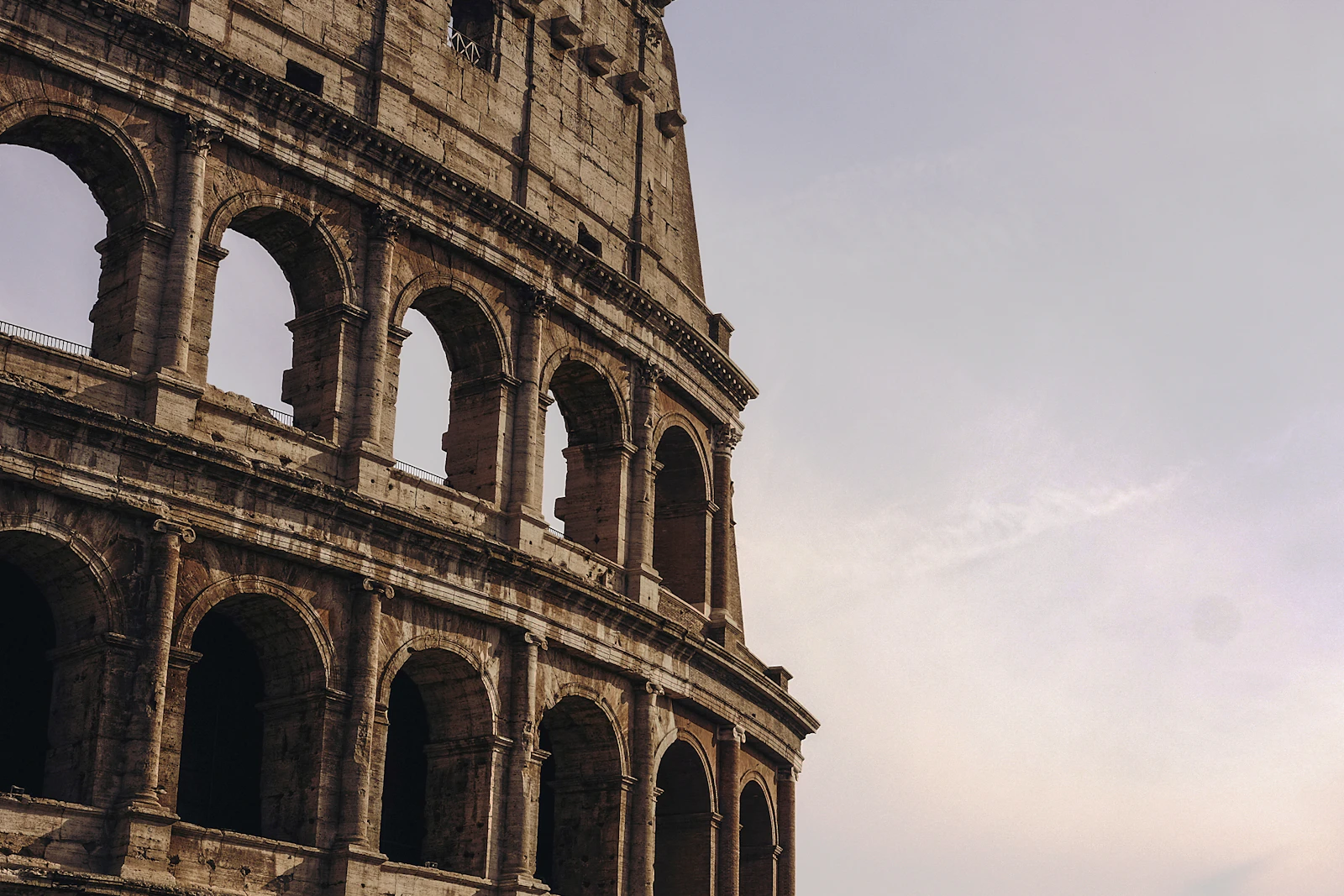 The Colosseum in Rome at sunset with dramatic sky