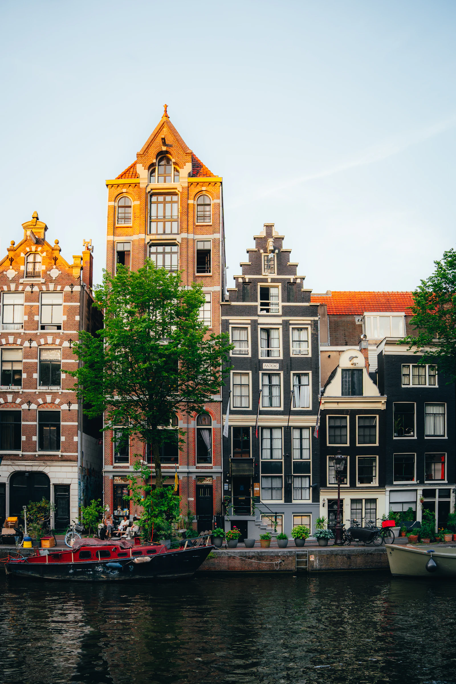 Row of historic Dutch canal houses along the water in Amsterdam