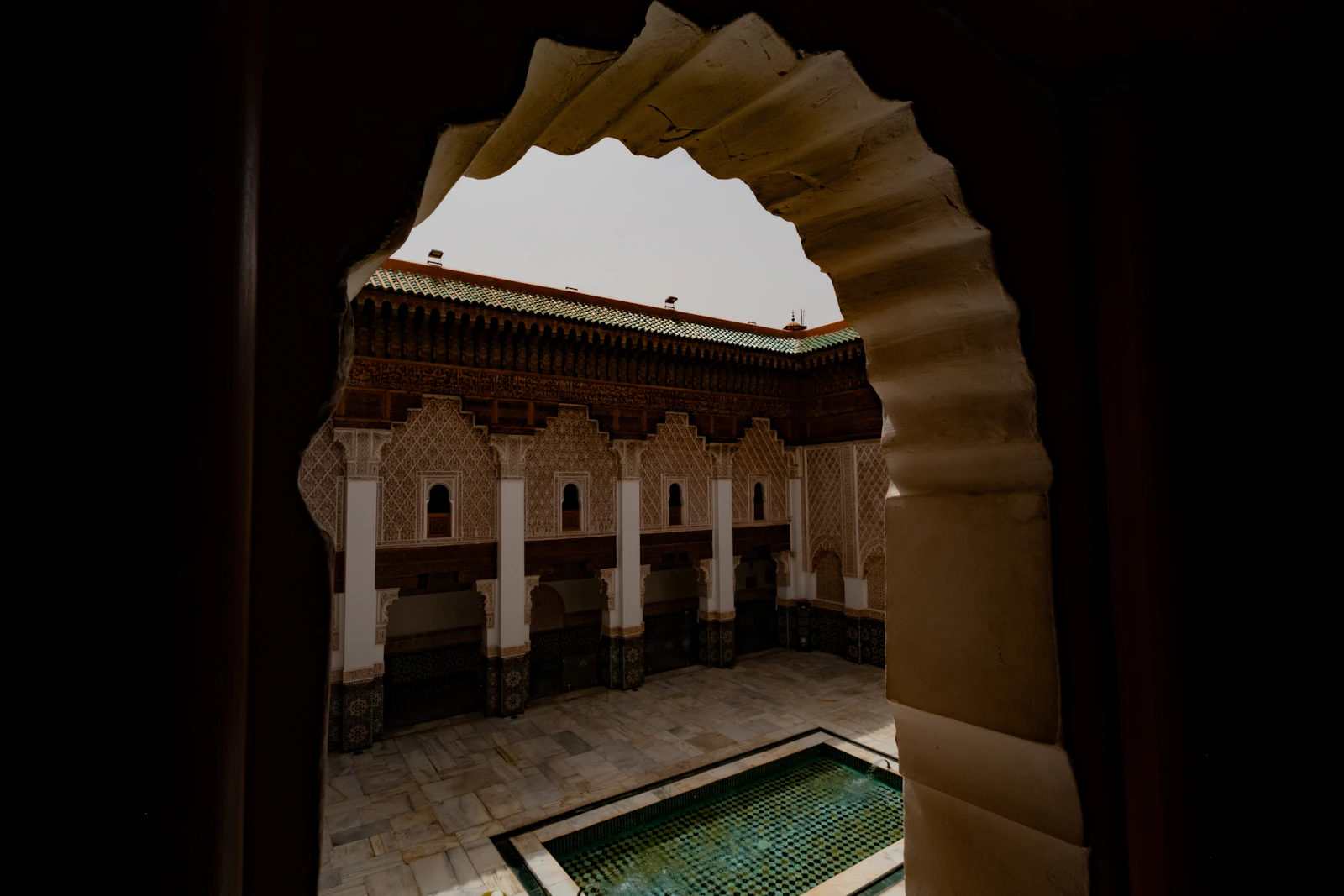 Courtyard with ornate arches and pool in a Marrakech riad