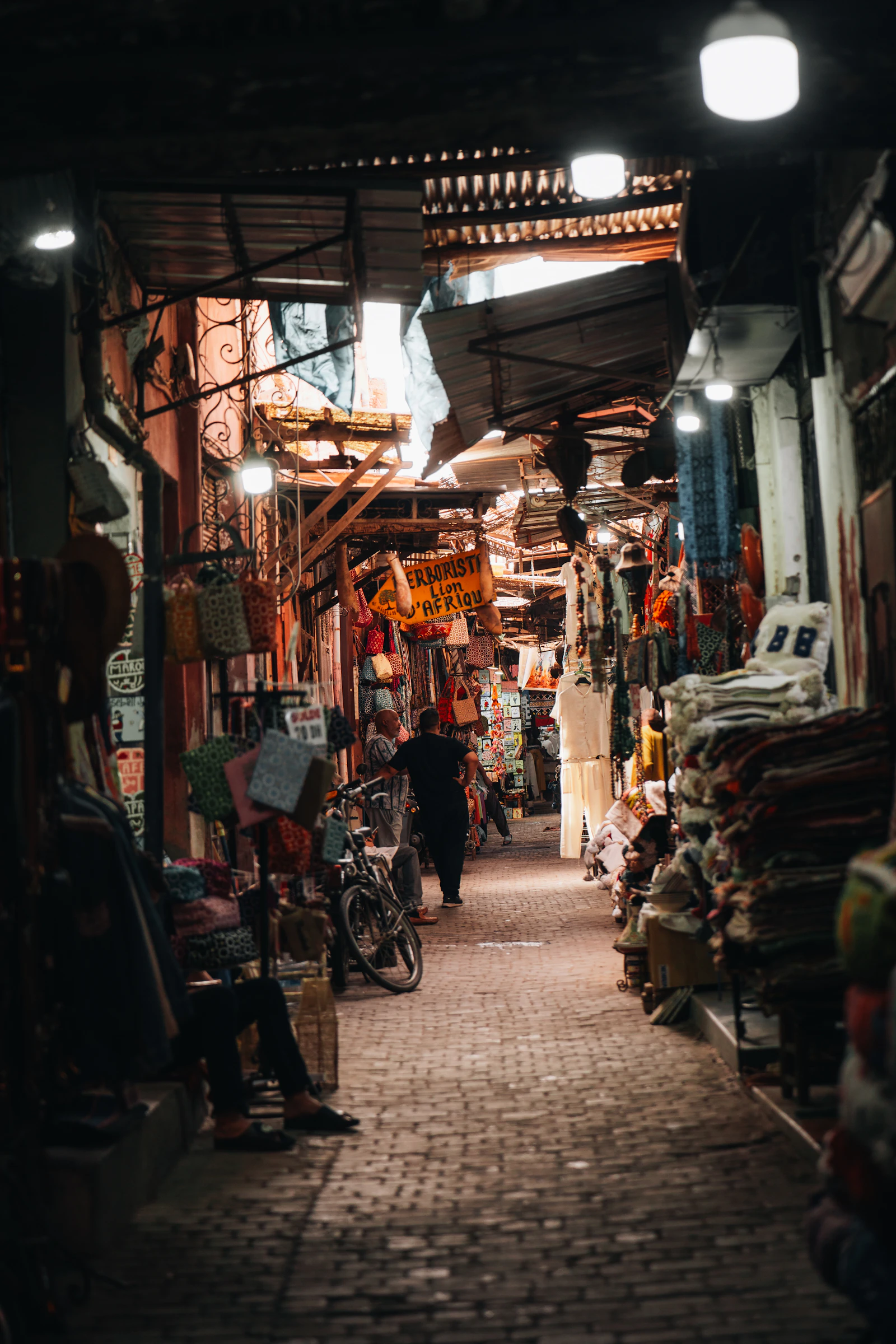 Bustling marketplace with stalls and shoppers in Marrakech souks
