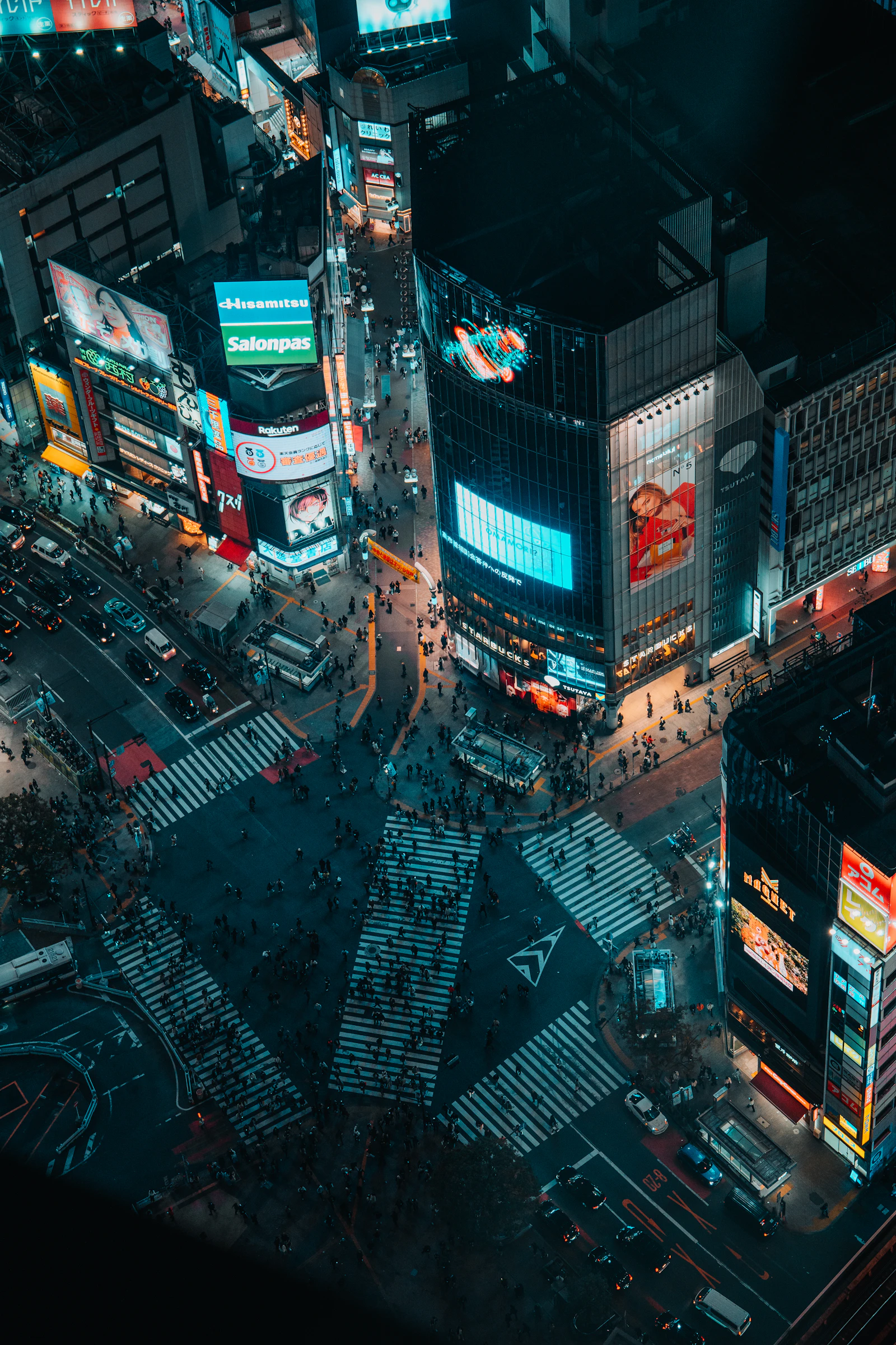 Shibuya Crossing at night with neon lights in Tokyo